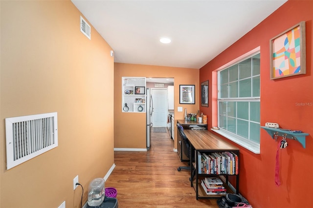 8556 91st Ter, Seminole, FL 33777 - hall featuring wood finished floors and baseboards