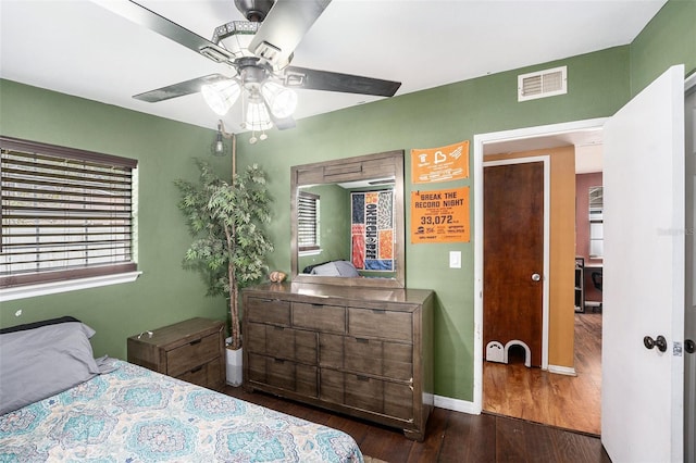 8556 91st Ter, Seminole, FL 33777 - bedroom featuring wood finished floors, baseboards, and a ceiling fan