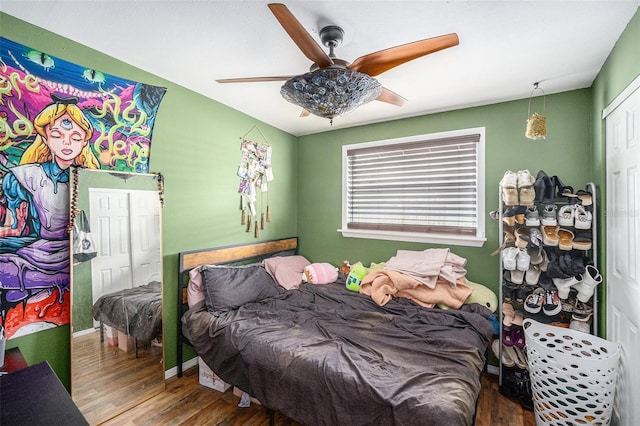 8556 91st Ter, Seminole, FL 33777 - bedroom with wood finished floors, a ceiling fan, and baseboards