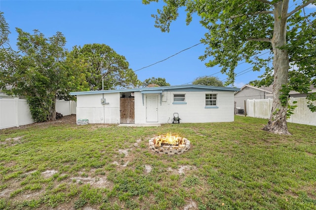 8556 91st Ter, Seminole, FL 33777 - rear view of house with an outdoor fire pit and central air condition unit