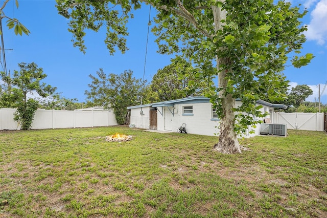 8556 91st Ter, Seminole, FL 33777 - view of yard with a gate, an outdoor fire pit, and central air condition unit