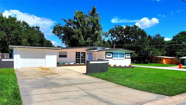 1373 Fairfax Rd, Clearwater, FL 33764 - ranch-style home with stucco siding, driveway, a front yard, and a garage
