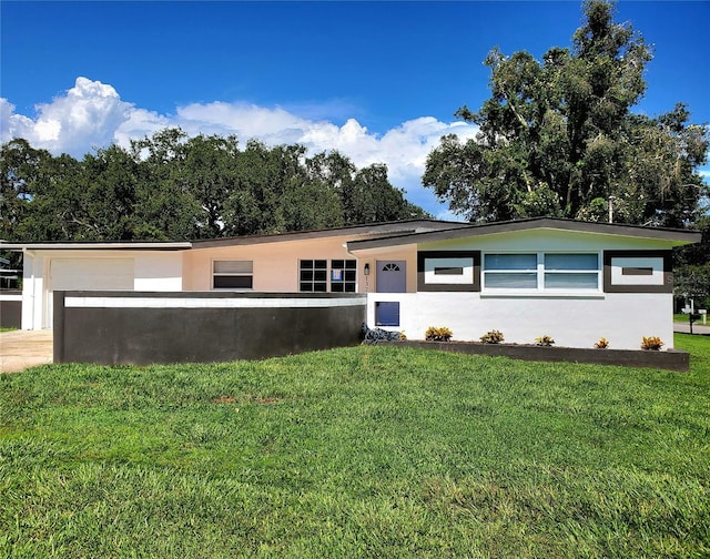 1373 Fairfax Rd, Clearwater, FL 33764 - ranch-style home with stucco siding, a front yard, and a garage