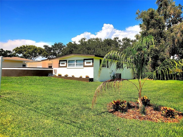 1373 Fairfax Rd, Clearwater, FL 33764 - view of side of property with stucco siding and a lawn