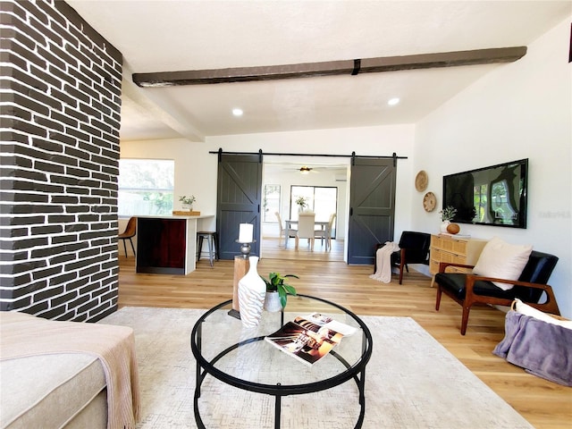 1373 Fairfax Rd, Clearwater, FL 33764 - living area with a barn door, beamed ceiling, wood finished floors, and recessed lighting
