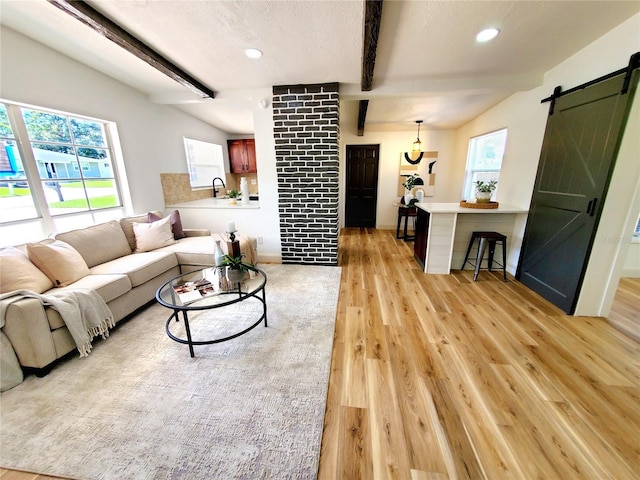 1373 Fairfax Rd, Clearwater, FL 33764 - living room featuring a barn door, beam ceiling, light wood-style floors, and recessed lighting