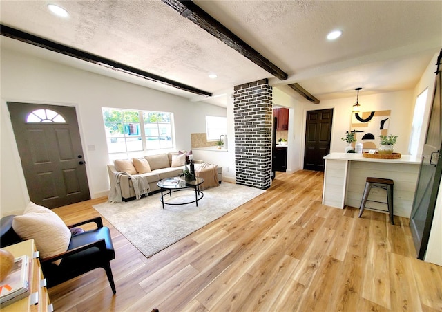 1373 Fairfax Rd, Clearwater, FL 33764 - living room with light wood-style flooring, beam ceiling, recessed lighting, and a textured ceiling
