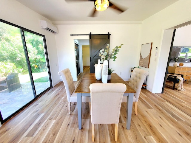 1373 Fairfax Rd, Clearwater, FL 33764 - dining space featuring a barn door, a wall mounted AC, light wood-type flooring, and a ceiling fan