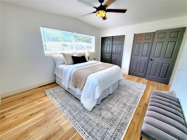 1373 Fairfax Rd, Clearwater, FL 33764 - bedroom with multiple closets, lofted ceiling, light wood-style floors, and ceiling fan