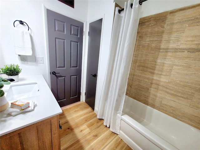1373 Fairfax Rd, Clearwater, FL 33764 - full bathroom featuring vanity, shower / bath combo, and wood finished floors