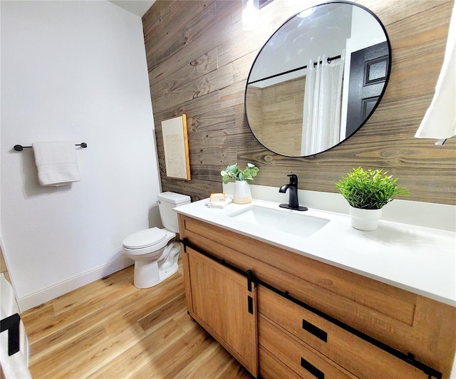 1373 Fairfax Rd, Clearwater, FL 33764 - bathroom featuring vanity, wooden walls, and wood finished floors