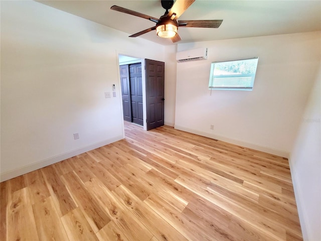 1373 Fairfax Rd, Clearwater, FL 33764 - spare room with an AC wall unit, ceiling fan, and light wood finished floors