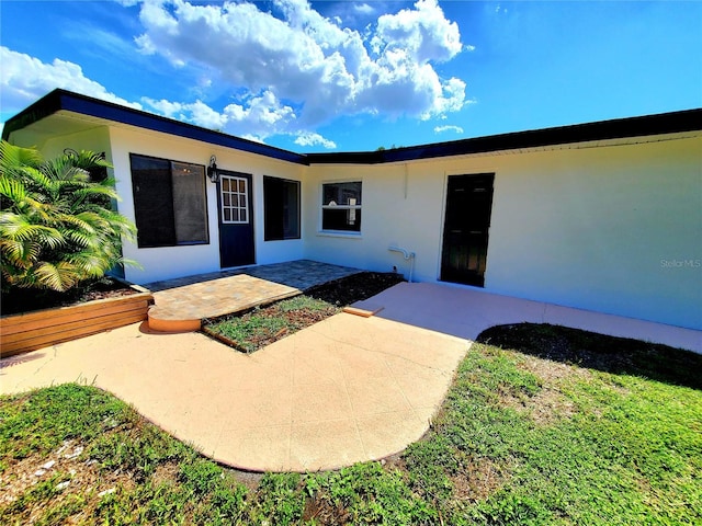 1373 Fairfax Rd, Clearwater, FL 33764 - entrance to property featuring stucco siding and a patio area