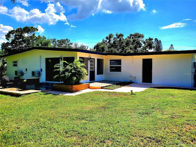 1373 Fairfax Rd, Clearwater, FL 33764 - view of front of home featuring stucco siding, a patio, and a front lawn
