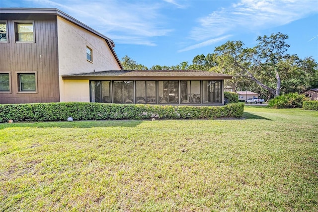 1400 Tarpon Woods Blvd Unit A4, Palm Harbor, FL 34685 - rear view of house with a sunroom and a yard
