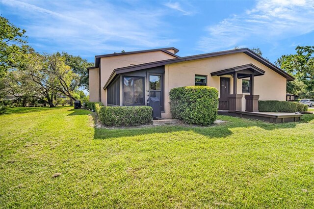 1400 Tarpon Woods Blvd Unit A4, Palm Harbor, FL 34685 - view of front facade featuring stucco siding and a front lawn