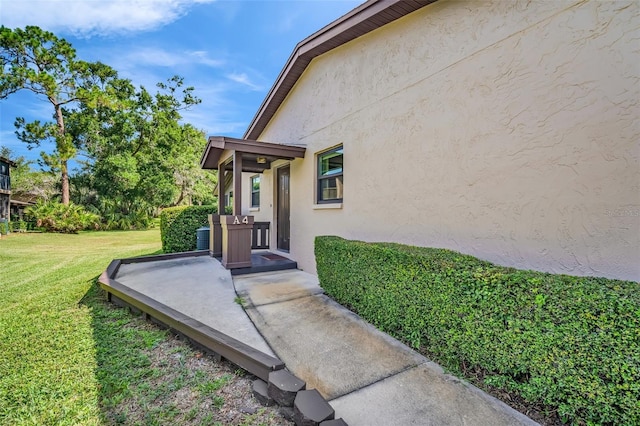 1400 Tarpon Woods Blvd Unit A4, Palm Harbor, FL 34685 - property entrance featuring stucco siding and a lawn