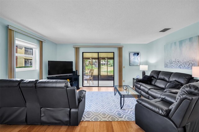 1400 Tarpon Woods Blvd Unit A4, Palm Harbor, FL 34685 - living area featuring a textured ceiling and wood finished floors