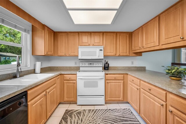 1400 Tarpon Woods Blvd Unit A4, Palm Harbor, FL 34685 - kitchen with white appliances, a sink, light tile patterned flooring, and light countertops