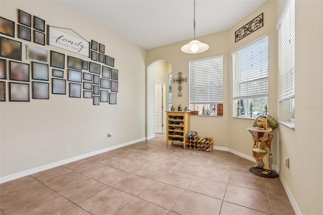 14494 Copeland Way, Brooksville, FL 34604 - dining area with arched walkways, tile patterned floors, and baseboards