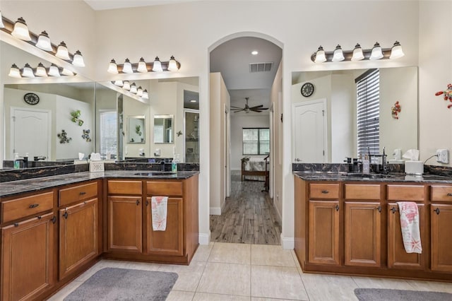 14494 Copeland Way, Brooksville, FL 34604 - ensuite bathroom featuring two vanities, ceiling fan, tile patterned flooring, and baseboards