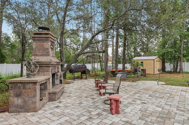 14494 Copeland Way, Brooksville, FL 34604 - fenced backyard with an outdoor stone fireplace, a patio area, and a grill