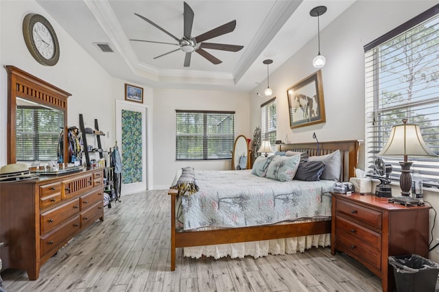 14494 Copeland Way, Brooksville, FL 34604 - bedroom with a raised ceiling, wood finished floors, multiple windows, crown molding, and ceiling fan