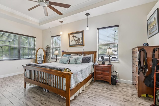 14494 Copeland Way, Brooksville, FL 34604 - bedroom with light wood-style flooring, a tray ceiling, ornamental molding, baseboards, and ceiling fan