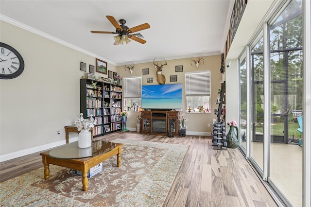 14494 Copeland Way, Brooksville, FL 34604 - living area featuring plenty of natural light, wood finished floors, ceiling fan, crown molding, and baseboards