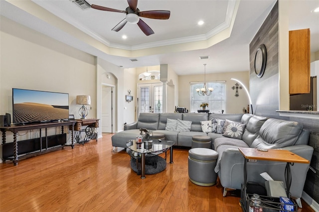 14494 Copeland Way, Brooksville, FL 34604 - living area featuring a raised ceiling, wood finished floors, ceiling fan, crown molding, and a chandelier