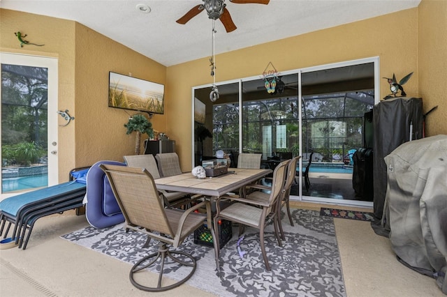 14494 Copeland Way, Brooksville, FL 34604 - dining space featuring a textured wall, a ceiling fan, a sunroom, and vaulted ceiling