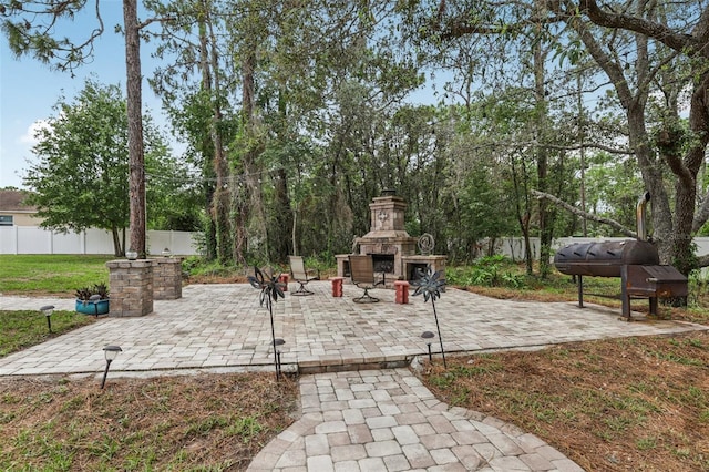 14494 Copeland Way, Brooksville, FL 34604 - view of patio / terrace with an outdoor stone fireplace