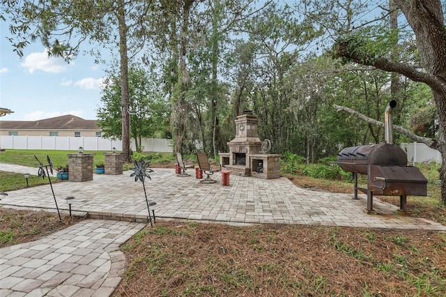 14494 Copeland Way, Brooksville, FL 34604 - view of patio / terrace with an outdoor stone fireplace
