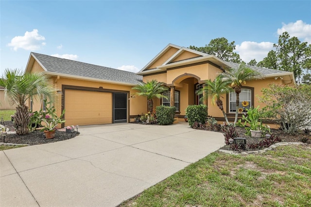 14494 Copeland Way, Brooksville, FL 34604 - view of front of property with stucco siding, a garage, and driveway