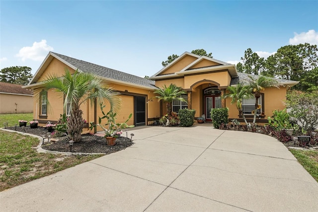 14494 Copeland Way, Brooksville, FL 34604 - view of front facade with concrete driveway, a garage, and stucco siding