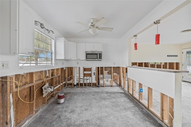 260 42nd Ave, St Pete Beach, FL 33706 - misc room with ceiling fan and unfinished concrete floors