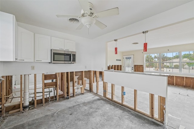260 42nd Ave, St Pete Beach, FL 33706 - kitchen featuring stainless steel microwave, white cabinets, a ceiling fan, and decorative light fixtures