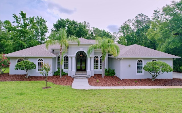 27511 Hialeah Way, Wesley Chapel, FL 33544 - view of front of home with french doors, a front yard, and stucco siding