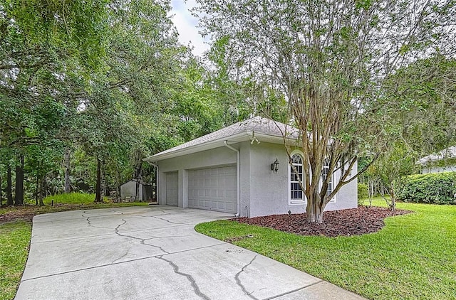 27511 Hialeah Way, Wesley Chapel, FL 33544 - view of property exterior featuring stucco siding, concrete driveway, a lawn, and an attached garage
