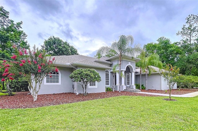 27511 Hialeah Way, Wesley Chapel, FL 33544 - view of front facade featuring stucco siding and a front lawn