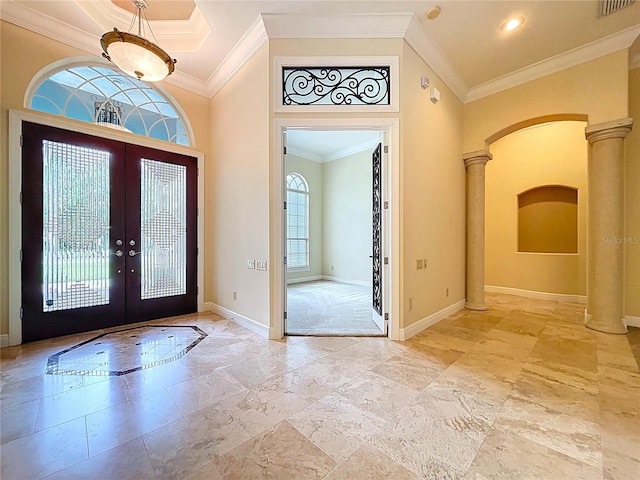 27511 Hialeah Way, Wesley Chapel, FL 33544 - foyer entrance featuring arched walkways, french doors, baseboards, ornate columns, and crown molding