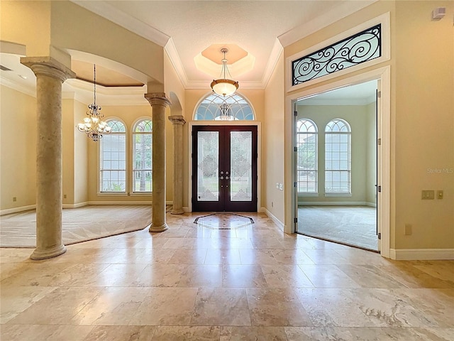27511 Hialeah Way, Wesley Chapel, FL 33544 - foyer entrance featuring ornamental molding, decorative columns, french doors, baseboards, and healthy amount of natural light