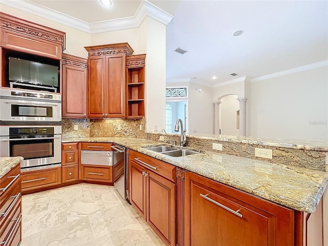 27511 Hialeah Way, Wesley Chapel, FL 33544 - kitchen with a sink, appliances with stainless steel finishes, ornate columns, a peninsula, and light stone countertops