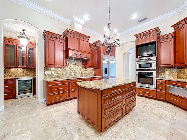 27511 Hialeah Way, Wesley Chapel, FL 33544 - kitchen featuring wine cooler, a warming drawer, stainless steel appliances, backsplash, and ornamental molding