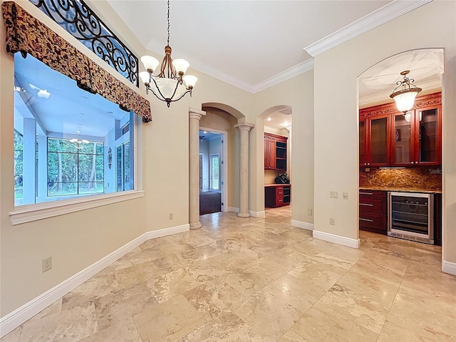 27511 Hialeah Way, Wesley Chapel, FL 33544 - unfurnished dining area featuring beverage cooler, arched walkways, decorative columns, healthy amount of natural light, and crown molding