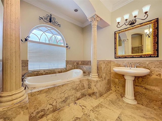 27511 Hialeah Way, Wesley Chapel, FL 33544 - bathroom with a bath, tile walls, crown molding, decorative columns, and wainscoting