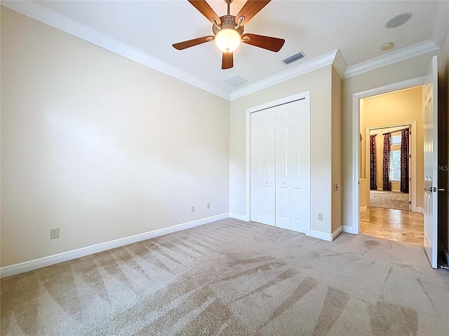 27511 Hialeah Way, Wesley Chapel, FL 33544 - unfurnished bedroom with light carpet, baseboards, ornamental molding, a closet, and ceiling fan