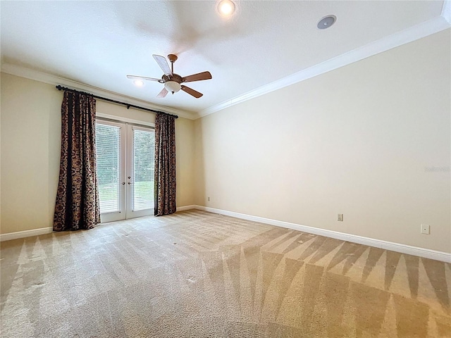 27511 Hialeah Way, Wesley Chapel, FL 33544 - empty room with crown molding, baseboards, french doors, a ceiling fan, and light carpet