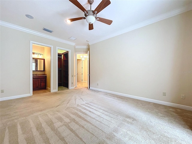 27511 Hialeah Way, Wesley Chapel, FL 33544 - unfurnished bedroom with light carpet, ornamental molding, baseboards, and a walk in closet