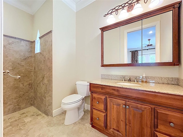 27511 Hialeah Way, Wesley Chapel, FL 33544 - bathroom with crown molding, toilet, vanity, tiled shower, and baseboards